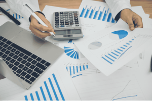 Documents financiers et graphiques de performance analysés sur un bureau professionnel